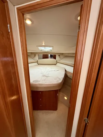  Yacht Photos Pics Interior cabin of 2004 Meridian 381 Sedan yacht with cozy bed and wooden accents.