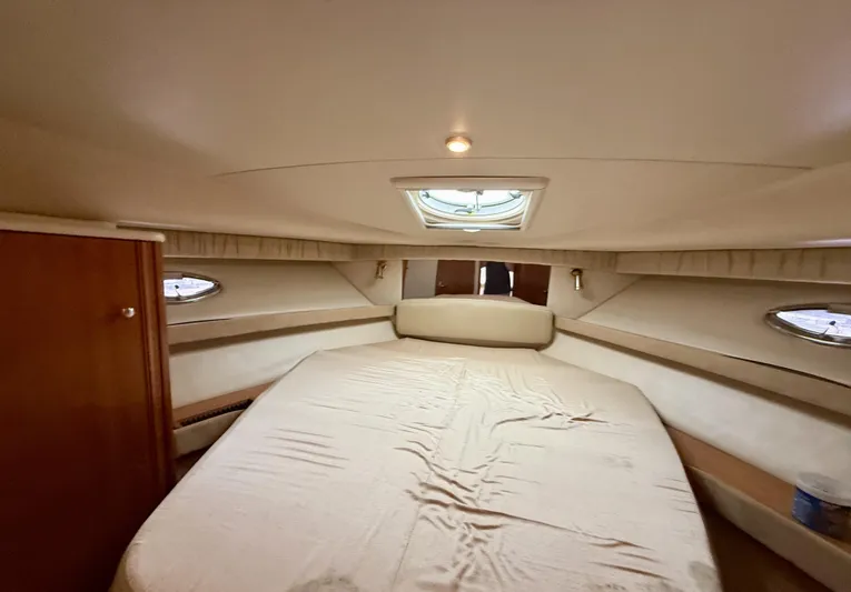  Yacht Photos Pics Luxurious cabin interior of 2004 Meridian 381 Sedan yacht with cozy bed and portholes.