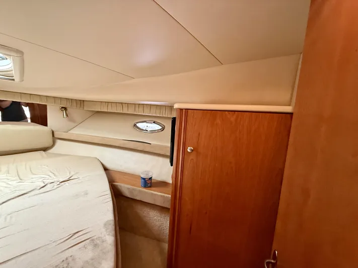  Yacht Photos Pics Interior cabin of 2004 Meridian 381 Sedan yacht with bed and wooden cabinetry.
