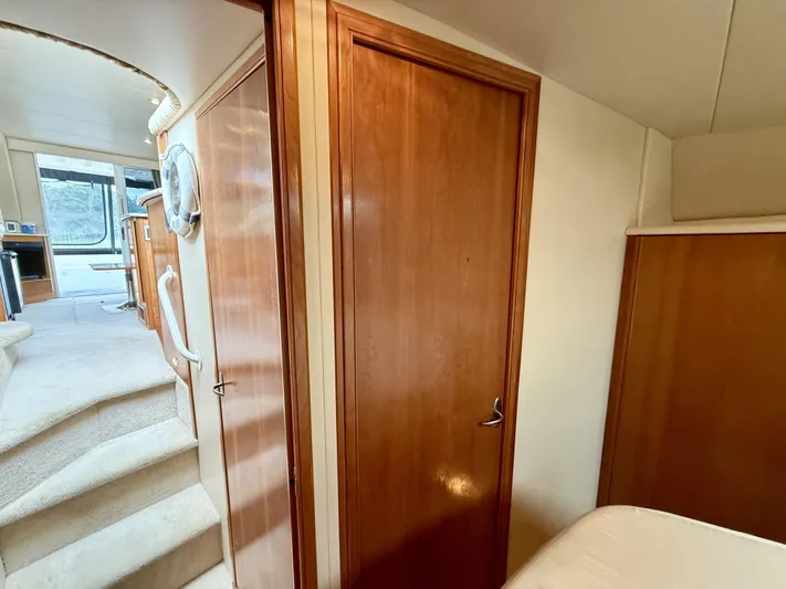  Yacht Photos Pics Interior of 2004 Meridian 381 Sedan yacht, featuring wooden doors and carpeted stairs.