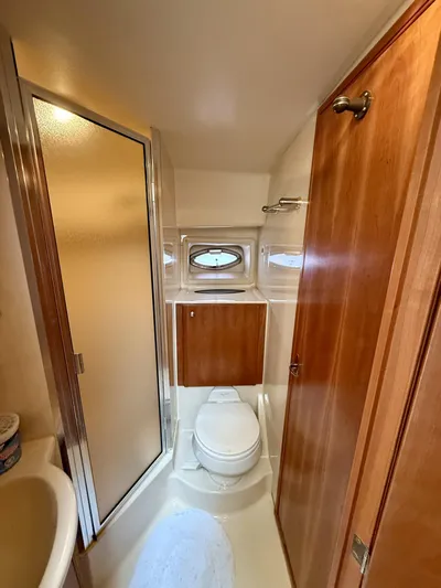  Yacht Photos Pics Compact bathroom in 2004 Meridian 381 Sedan yacht with shower and wooden cabinetry.
