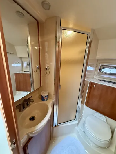  Yacht Photos Pics Bathroom interior of 2004 Meridian 381 Sedan yacht, featuring sink, toilet, and shower.