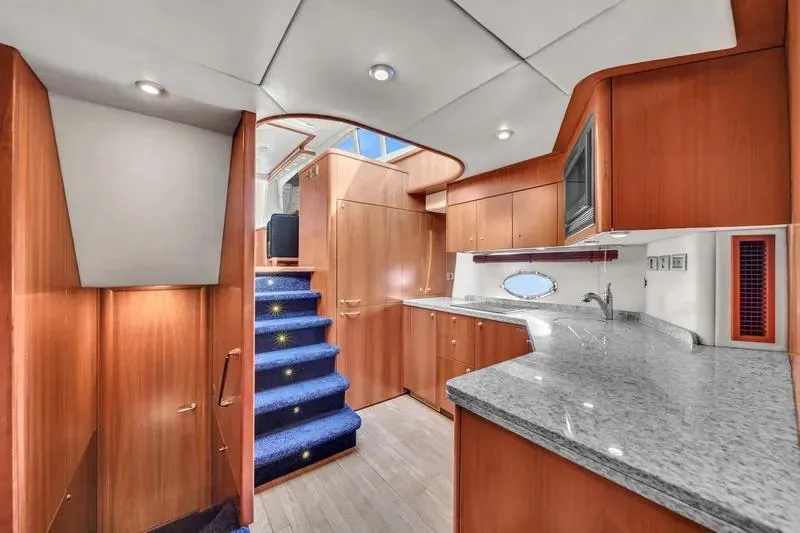  Yacht Photos Pics Luxurious interior of 2006 Sunseeker Predator 72 yacht with modern kitchen and staircase.