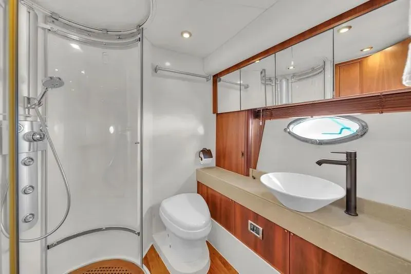  Yacht Photos Pics Luxurious bathroom in 2006 Sunseeker Predator 72 yacht with modern fixtures and wood accents.