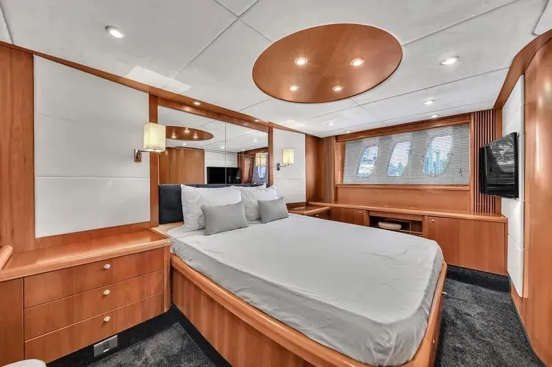  Yacht Photos Pics Luxurious bedroom interior of 2006 Sunseeker Predator 72 yacht with modern wood finishes.