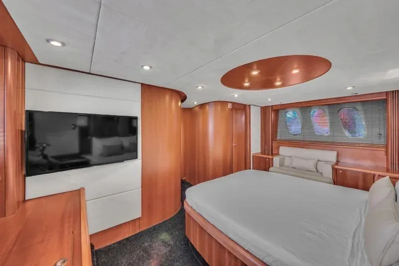  Yacht Photos Pics Luxurious interior of 2006 Sunseeker Predator 72 yacht with modern wood finishes and cozy bedding.