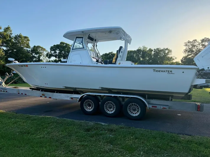  Yacht Photos Pics 2025 Tidewater 3100 Carolina Bay boat on a trailer, parked outdoors.