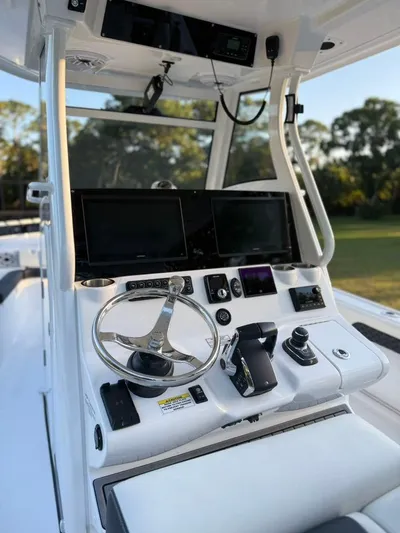  Yacht Photos Pics 2025 Tidewater 3100 Carolina Bay boat console with modern controls and dual screens.