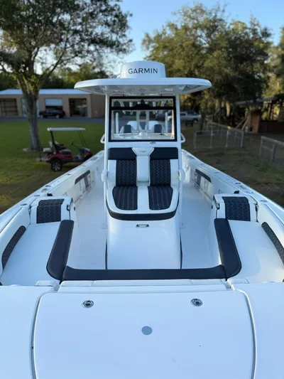  Yacht Photos Pics 2025 Tidewater 3100 Carolina Bay boat with Garmin equipment, docked outdoors.