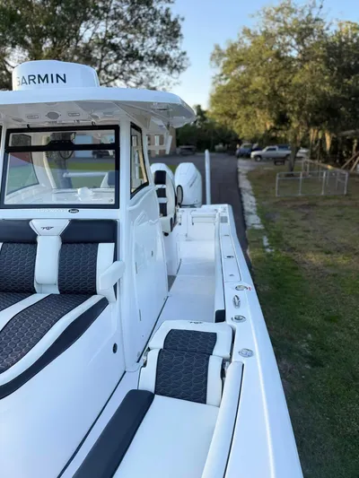  Yacht Photos Pics 2025 Tidewater 3100 Carolina Bay boat with sleek design and modern features, docked outdoors.