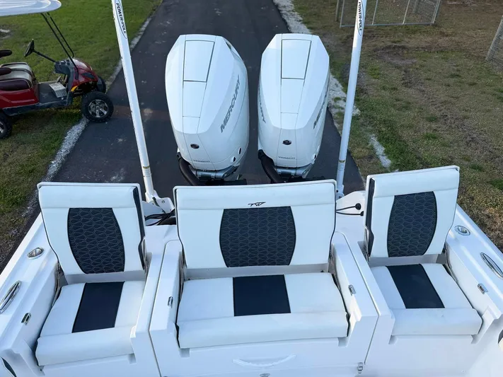  Yacht Photos Pics 2025 Tidewater 3100 Carolina Bay boat with triple Mercury engines and cushioned seating.