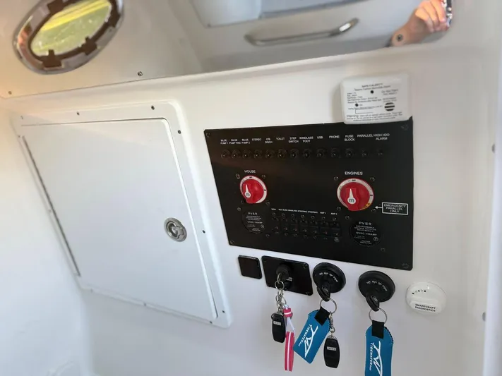  Yacht Photos Pics Control panel of 2025 Tidewater 3100 Carolina Bay boat with keys and switches.