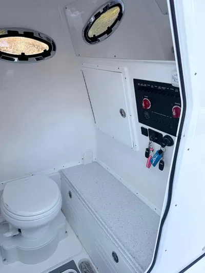  Yacht Photos Pics 2025 Tidewater 3100 Carolina Bay boat interior with toilet and control panel.