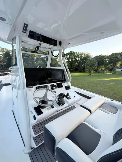  Yacht Photos Pics 2025 Tidewater 3100 Carolina Bay boat interior with modern helm and dual screens.