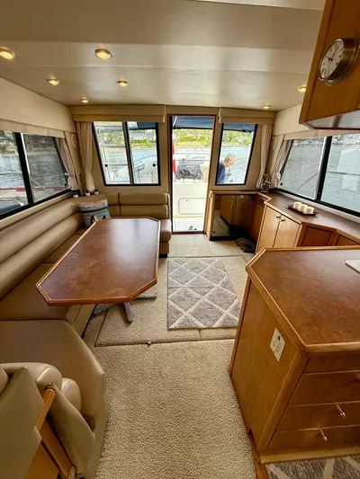 Perfect Ten Yacht Photos Pics Interior of 1999 Bayliner 3788 Command Bridge Motoryacht with dining area and kitchenette.