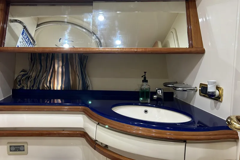  Yacht Photos Pics Luxurious bathroom interior of a 2003 Azimut 55 yacht with elegant wood accents.
