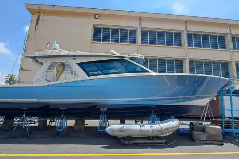  Yacht Photos Pics 2022 Scout 530 LXF boat on stands near industrial building.
