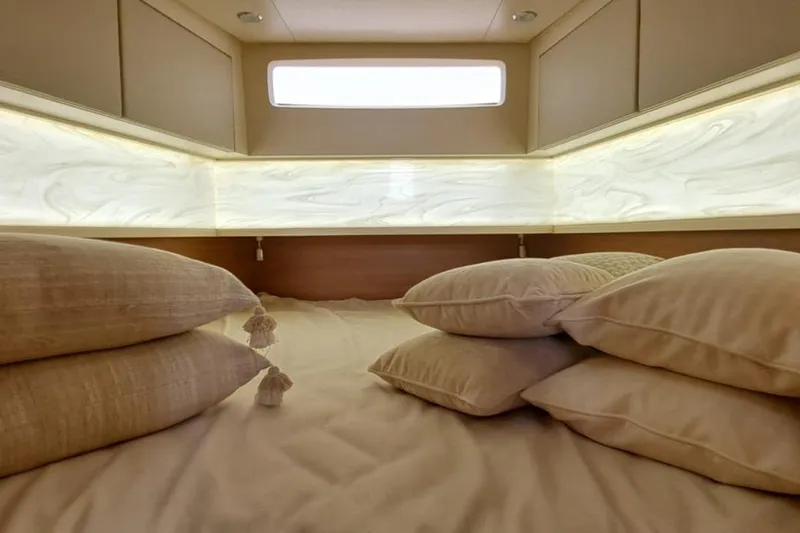  Yacht Photos Pics Luxurious cabin interior of 2022 Scout 530 LXF yacht with plush pillows and ambient lighting.