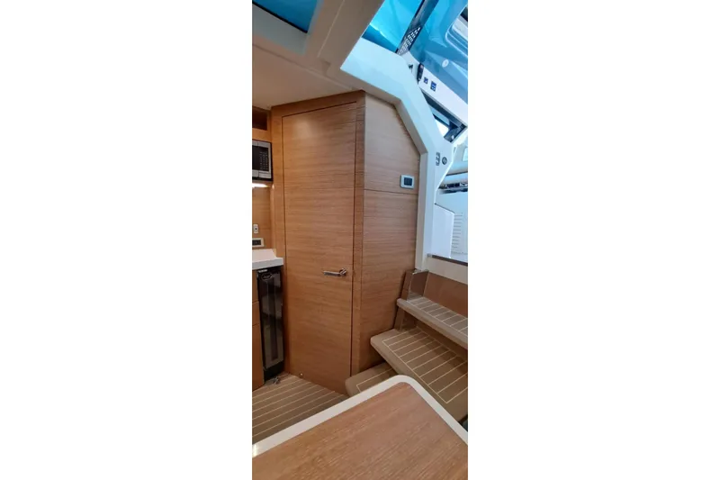 Yacht Photos Pics 2022 Scout 530 LXF interior with wooden cabinetry and stairs, showcasing modern design.