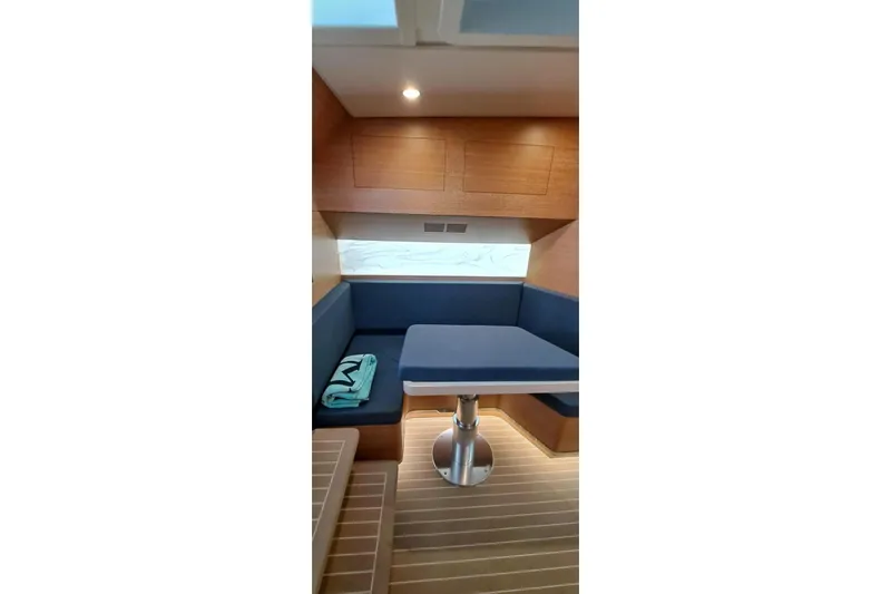  Yacht Photos Pics 2022 Scout 530 LXF cabin interior with wooden finish and blue seating.