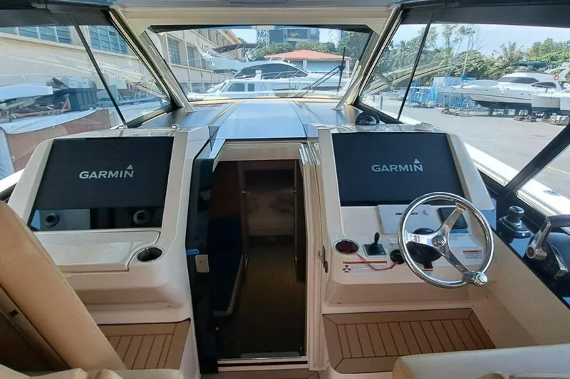  Yacht Photos Pics 2022 Scout 530 LXF boat cockpit with dual Garmin displays and steering wheel.