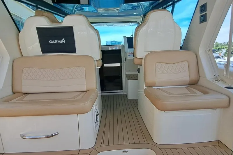  Yacht Photos Pics Interior of 2022 Scout 530 LXF boat with beige seating and Garmin display.