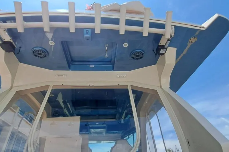  Yacht Photos Pics 2022 Scout 530 LXF boat interior with blue ceiling and speakers, viewed from below.