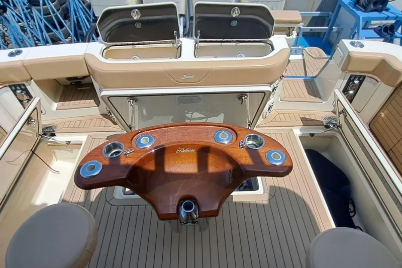  Yacht Photos Pics 2022 Scout 530 LXF boat interior with wooden table and seating area.