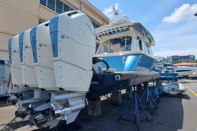  Yacht Photos Pics 2022 Scout 530 LXF boat with four powerful outboard engines in a marina setting.
