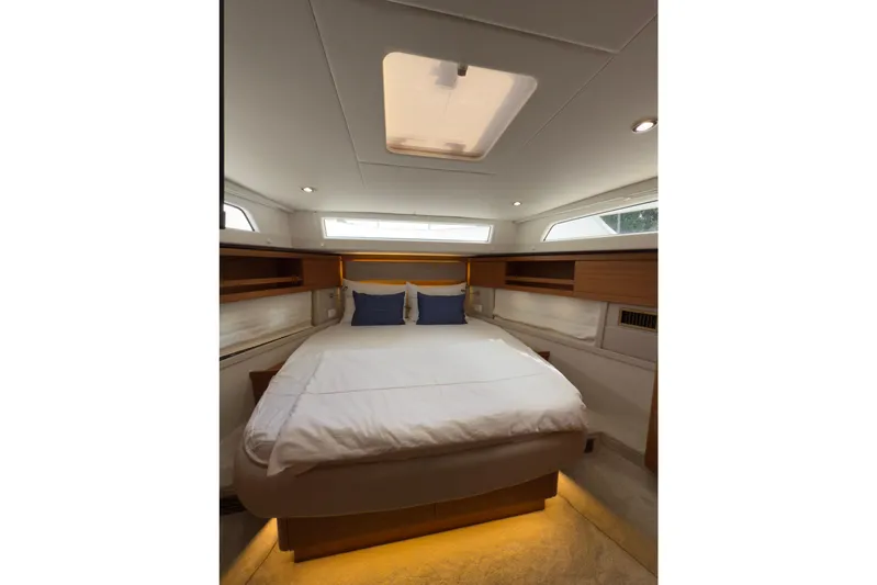 Waxing Gibbous Yacht Photos Pics Luxurious cabin interior of 2024 Greenline 48 Fly yacht with cozy bedding and ambient lighting.