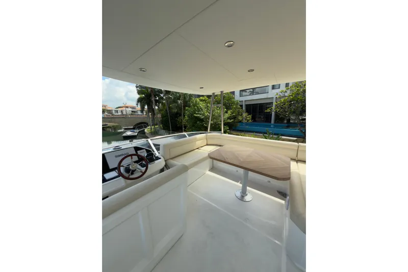 Waxing Gibbous Yacht Photos Pics Luxurious 2024 Greenline 48 Fly yacht interior with elegant seating and wooden table.