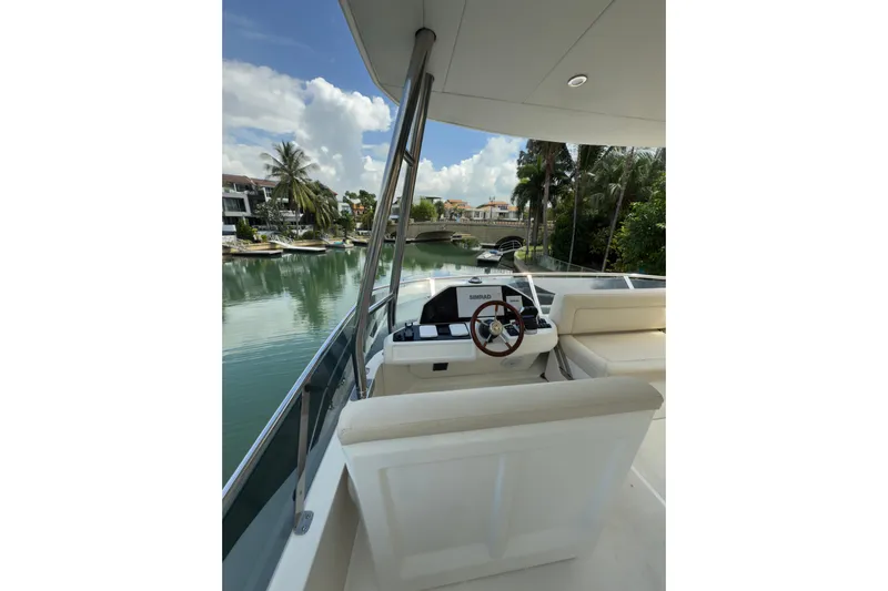 Waxing Gibbous Yacht Photos Pics 2024 Greenline 48 Fly yacht helm with scenic waterfront view.