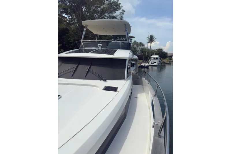 Waxing Gibbous Yacht Photos Pics 2024 Greenline 48 Fly yacht on a serene waterway, showcasing sleek design and solar panels.