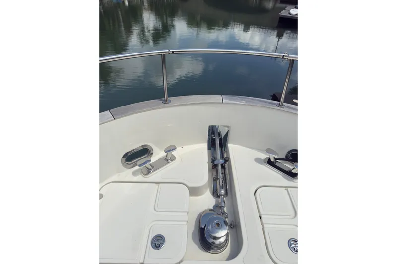Waxing Gibbous Yacht Photos Pics 2024 Greenline 48 Fly yacht bow with anchor and railing, reflecting water view.
