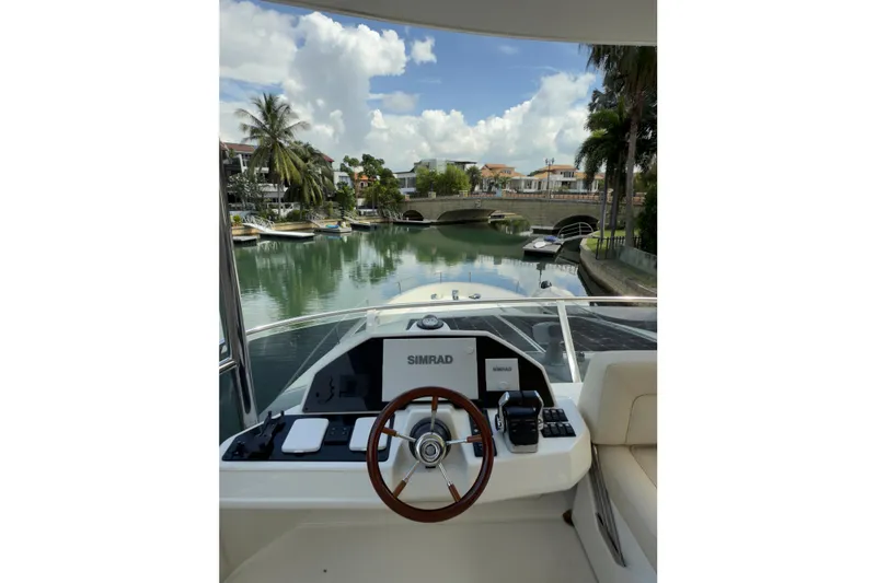 Waxing Gibbous Yacht Photos Pics 2024 Greenline 48 Fly yacht helm with scenic canal view.