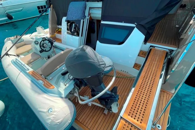  Yacht Photos Pics 2018 Absolute NAVETTA 58 yacht with tender boat and wooden deck in clear blue water.