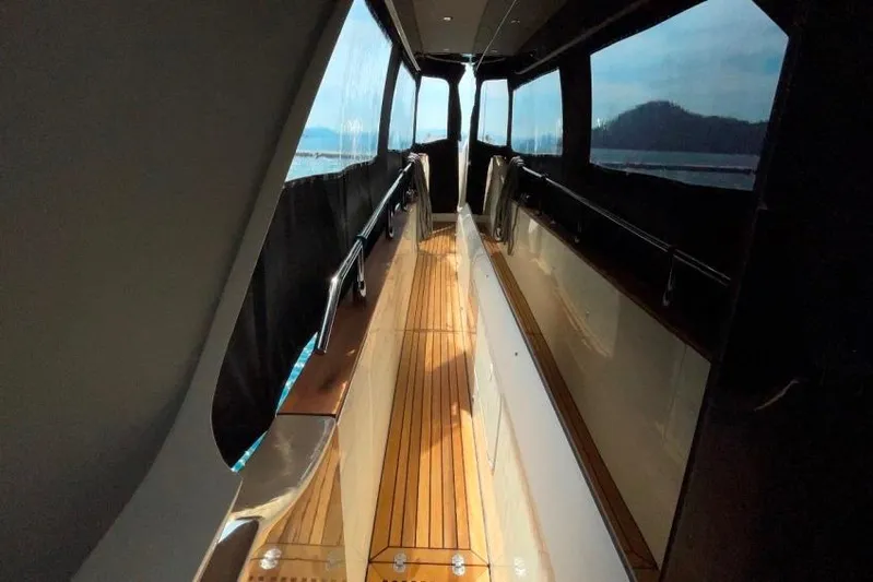  Yacht Photos Pics Side deck of 2018 Absolute NAVETTA 58 yacht with wooden flooring and panoramic windows.