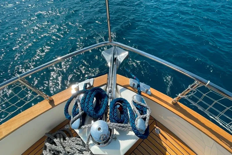  Yacht Photos Pics Bow of 2018 Absolute NAVETTA 58 yacht with ropes and anchor, overlooking blue ocean.
