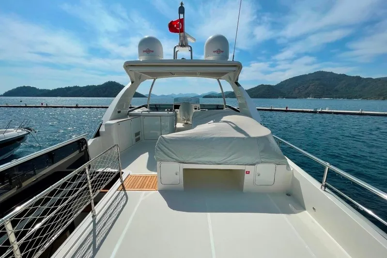  Yacht Photos Pics Luxurious 2018 Absolute NAVETTA 58 yacht on serene waters with scenic mountain backdrop.