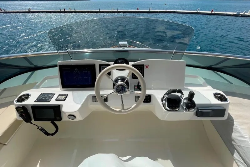  Yacht Photos Pics Cockpit of 2018 Absolute NAVETTA 58 yacht with steering wheel and navigation controls.