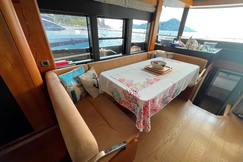  Yacht Photos Pics Interior of 2018 Absolute NAVETTA 58 yacht with dining area and sea view.