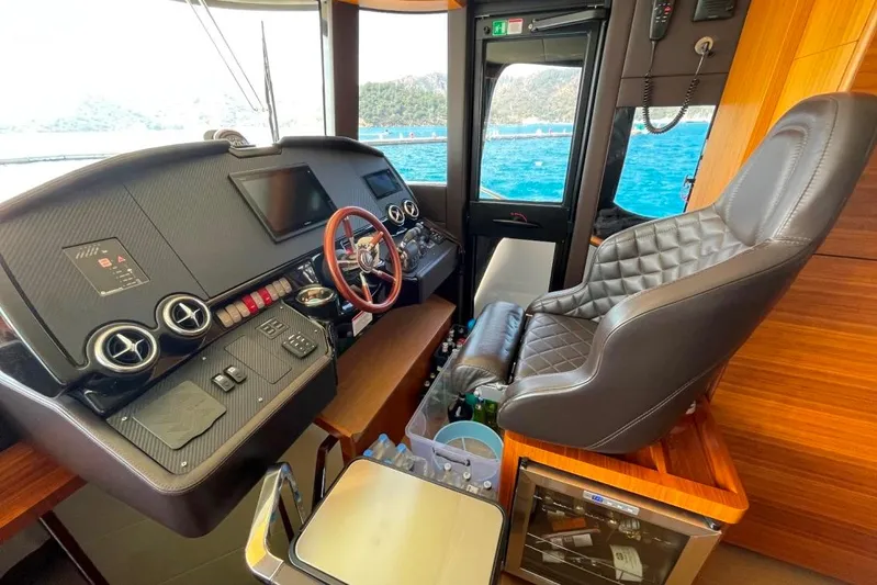  Yacht Photos Pics Luxurious helm of 2018 Absolute NAVETTA 58 yacht with leather seating and modern controls.