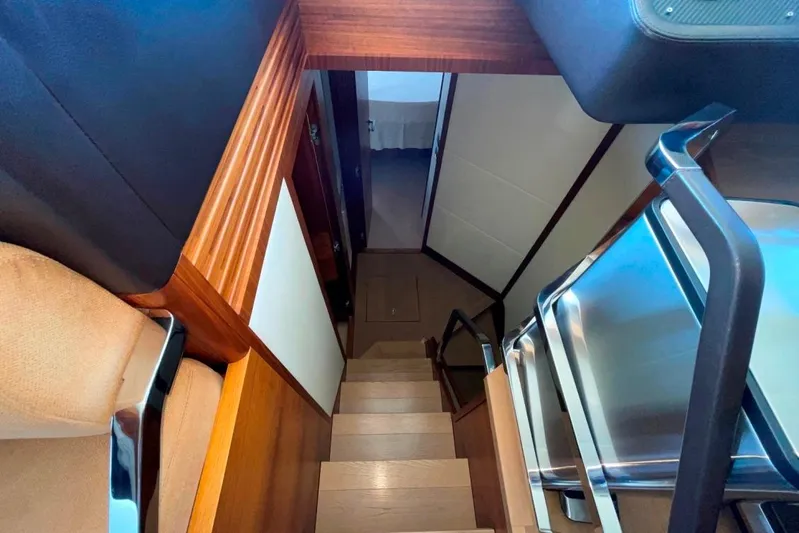  Yacht Photos Pics Staircase inside 2018 Absolute NAVETTA 58 yacht, featuring sleek wood and metal design.