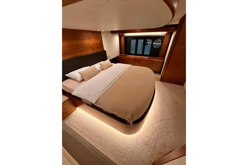  Yacht Photos Pics Luxurious bedroom interior of 2018 Absolute NAVETTA 58 yacht with elegant lighting and wood accents.