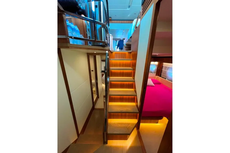  Yacht Photos Pics Luxurious interior of 2018 Absolute NAVETTA 58 yacht with illuminated staircase and cozy bedroom.