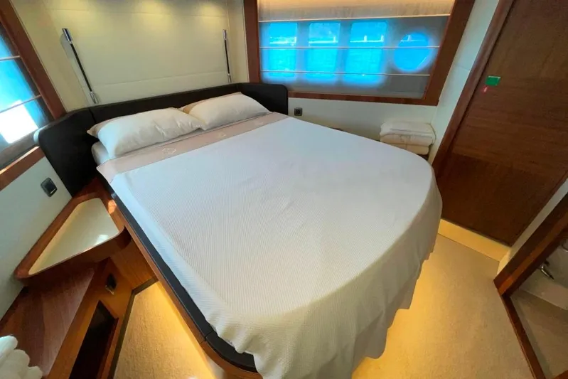  Yacht Photos Pics Luxurious bedroom interior of 2018 Absolute NAVETTA 58 yacht with cozy bed and ambient lighting.