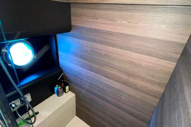  Yacht Photos Pics Interior of 2018 Absolute NAVETTA 58 yacht with wood paneling and porthole.