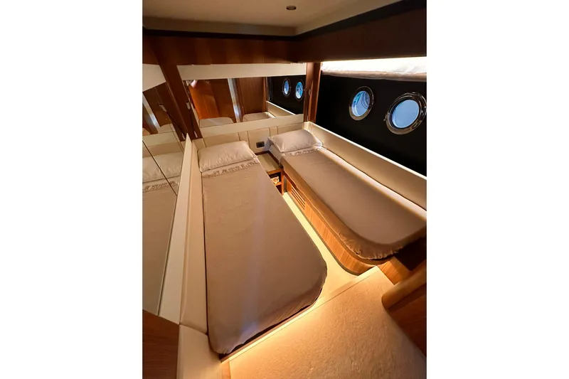 Yacht Photos Pics Luxurious cabin interior of 2018 Absolute NAVETTA 58 yacht with twin beds and portholes.