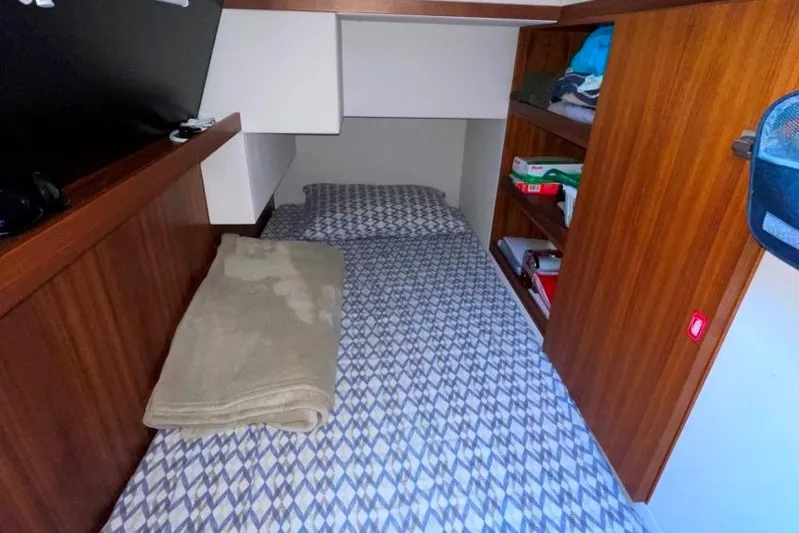  Yacht Photos Pics Cozy cabin bed in 2018 Absolute NAVETTA 58 yacht with wooden shelves and patterned bedding.
