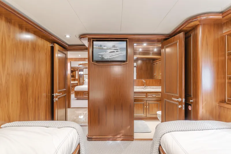 White Lotus Yacht Photos Pics Luxurious 2011 President Sterling Tri-Deck yacht interior with elegant wood finish and twin beds.